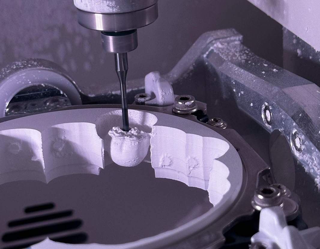 Close-up of a CNC milling machine creating detailed components.