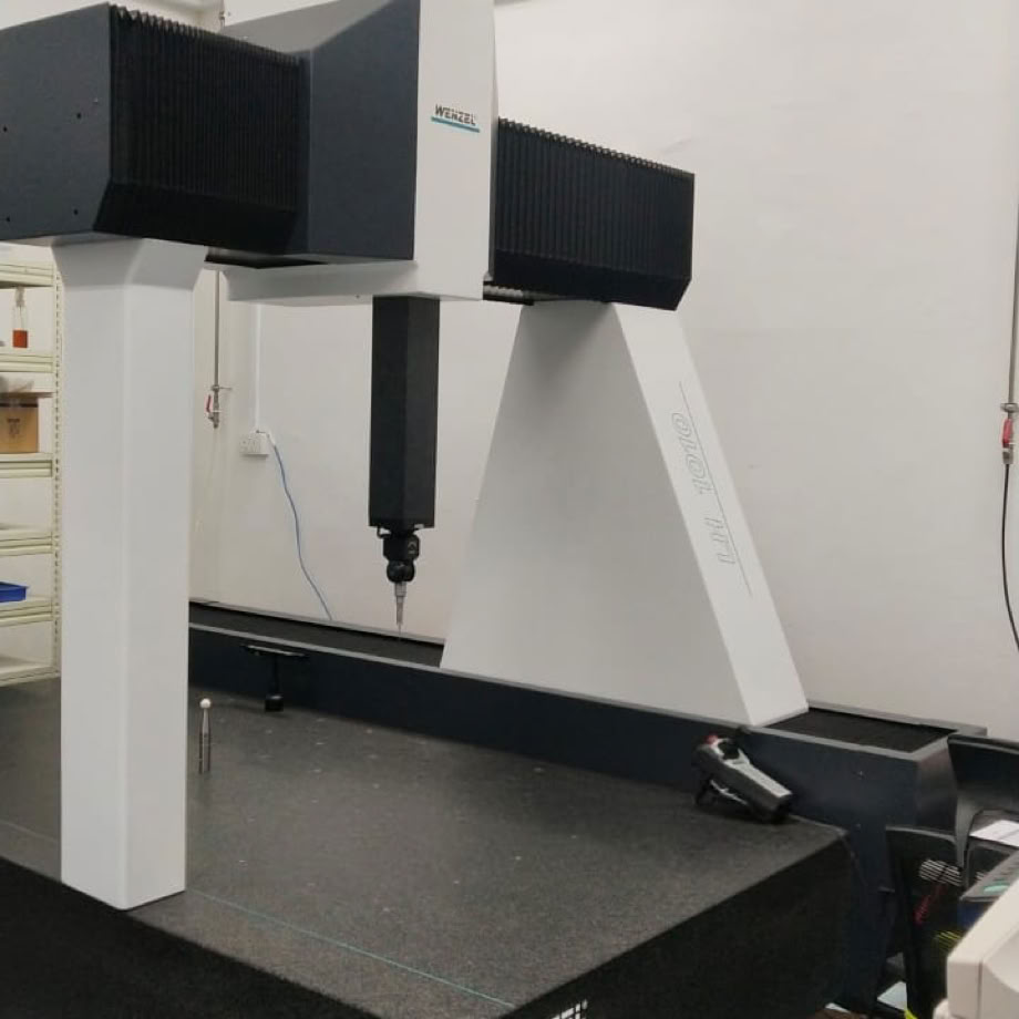 Close-up of an industrial CNC lathe in a bustling machine shop setting, focused on precision metalwork.
